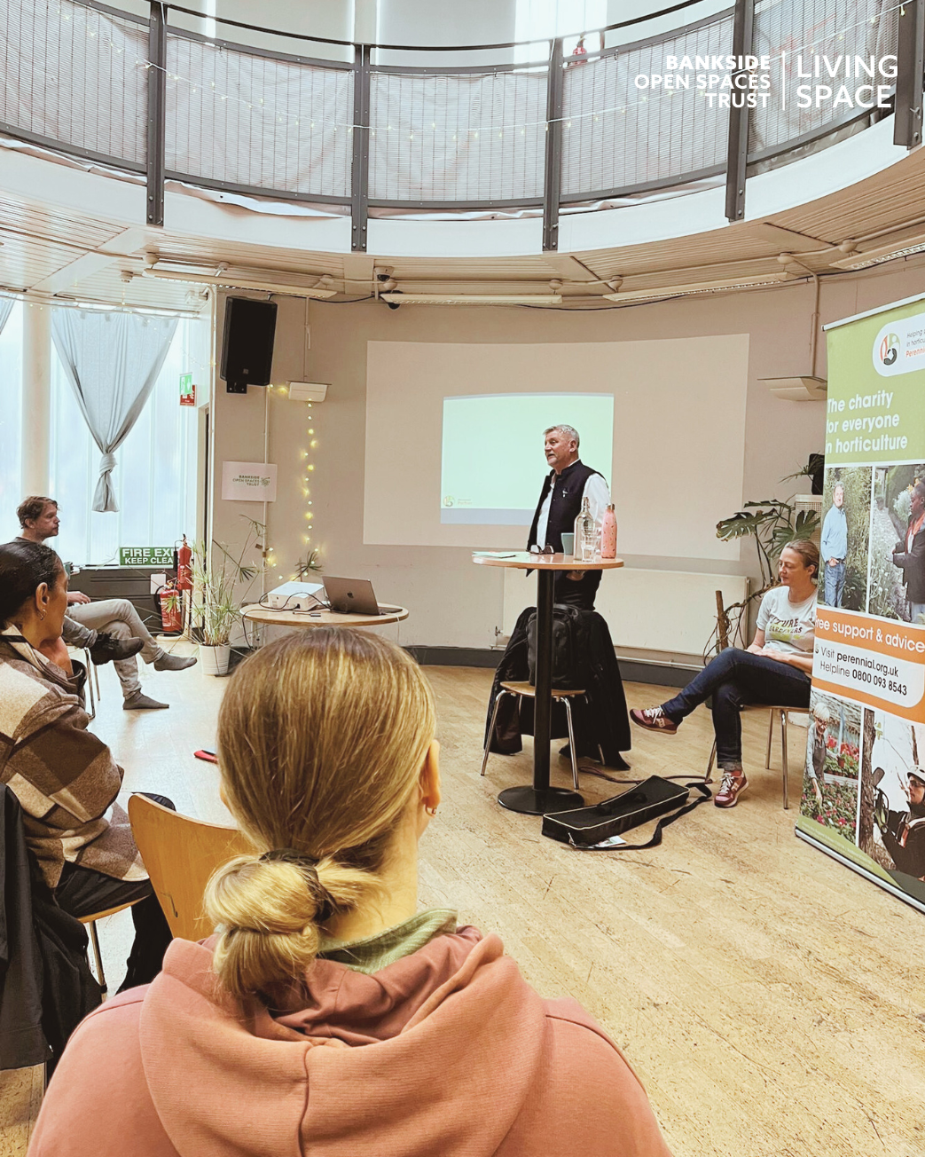 Mark Gregory standing at a lectern talking to an audience