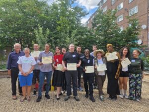 Future Gardeners 23rd Cohort posing with their graduation certificates with Chair of Trustees and Programme Team Louisa and Shereen